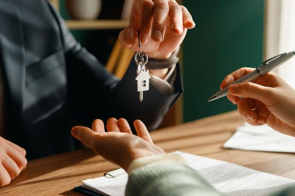 Leasing agent handing keys to new tenant